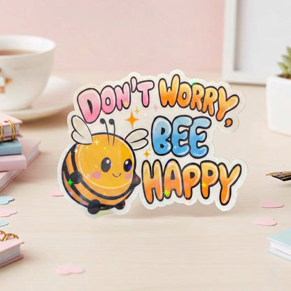 Kawaii Biene Die-Cut Sticker mit holografischem Schimmer-Effekt und buntem Don't Worry Bee Happy Schriftzug in Rosa, Blau und Orange, 6,5×5 cm